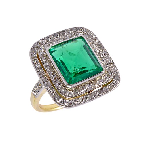 Early 20th century rectangular emerald and diamond cluster ring, c.1910, centred by a 3.59ct Colombian emerald of canted step-cut,